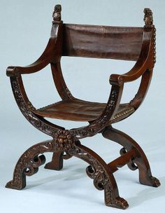 an ornate wooden chair with carved arms and legs