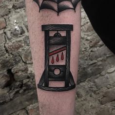 a tattoo on the leg of a man with an umbrella over his head and blood drops coming out of it