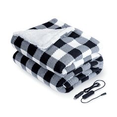 two black and white checkered blankets sitting on top of each other next to an electric charger