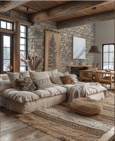 a living room filled with lots of furniture next to a stone wall covered in windows