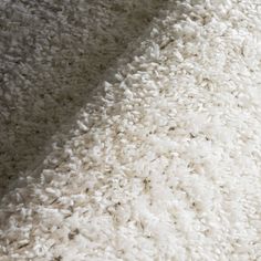 a close up view of a white carpet that has been made into a blanket or rug