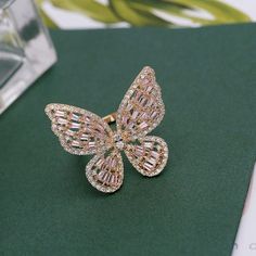 Description: Chic Inlaid Adjustable Butterfly Ring Specification:Size: 3.2 cm * 3 cmWeight: 7g/pcsMaterial: cubic zirconia, copper, 18k gold and silverHypoallergenic: YesCZ Colors: Pink/Clear Add a flutter of stylish chic to your fingers with this adjustable butterfly ring. The delicate butterfly design is eye-catching and inlaid with intricate patterns. Perfect for any outfit, this ring will surely make you stand out in the crowd. Butterfly Jewelry Set, Open Bangle Bracelet, Pearl Butterfly, Pearl Bangle, Pearl Jewelry Sets, Open Bangle, Butterfly Ring, Butterfly Jewelry, Pink Ring