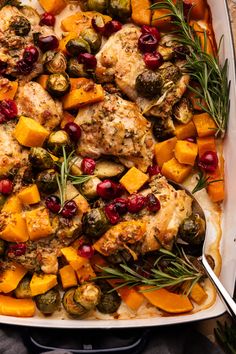 A roasting pan with chicken thighs, cut up butternut squash, cranberries, and brussels sprouts with fresh rosemary on top. Chicken And Squash Recipes, E2m Recipes, Chicken Squash, Easy Fall Dinners, Chicken And Butternut Squash