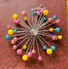 there are many colorful balls in the center of this pinwheel made out of candy canes