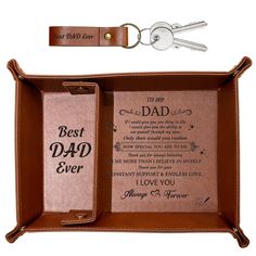 a leather case with two keychains attached to it and the words, best dad ever