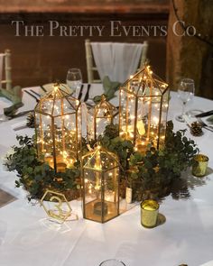 a table topped with lots of lights and greenery