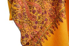 One of a kind shawl meticulously hand-embroidered by the finest needlework artisans of the world. Each shawl is unique and no two are alike.Opulence and mystique are the hallmarks of a hand embroidered Kashmir shawls. The elegance of this beautiful mustard gold shawl is an epitome of class displayed by the lustrous natural sheen of silk hand embroidery.The base fabric (Natural Pashmina) is handwoven from the inner coat/fleece of the central Asian species of antelope goat found at 14,000 ft above