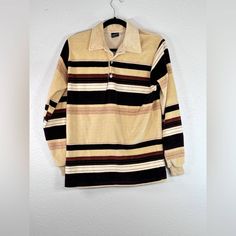 "Campus Velour vintage longsleeve stripe polo  various shades of brown  size Medium Good vintage condition there is a small whole at the end of one sleeve where thread is coming undone. Should be easy fix or leave it for distressed look. Small whole in armpit. Please see last two photos.  This is vintage so sizes run smaller. Please checkout measurements.  Approximate measurements:  Pit to pit: 20\" Shoulder to hem: 26.25\"" Beige Long Sleeve Tops With Striped Collar, Cotton Polo Sweater With Striped Collar, Casual Brown Long Sleeve Polo Sweater, Striped Collared Tops For Winter, Winter Striped Collared Top, Retro Collared Polo Sweater For Fall, Brown Long Sleeve Cotton Polo Sweater, Retro Long Sleeve Top With Striped Collar, Striped Long Sleeve Polo Shirt