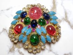 Christian Dior Brooch from 1967!  Great signed piece.  It is signed Christian Dior 67 Germany.  This is a nice collectible piece!  Great colors and really good stone colors.  Gold tone setting!  Mint vintage condition. More details please refer to the photos. Multicolor Cabochon Brooches For Collectors, Vintage Multicolor Multi-stone Brooch, Vintage Multicolor Collectible Brooches, Collectible Multicolor Costume Jewelry Brooches, Dior Brooch, Vintage Christian Dior, Heel Boots, High Heel Boots, Single Piece