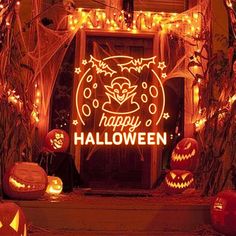 an entrance to a house decorated for halloween with pumpkins and jack - o'- lanterns