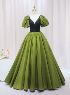 If your goal is to embody a blend of vintage charm and modern sophistication, this olive green prom dress is the quintessential choice. Perfectly capturing the essence of a timeless style with a contemporary twist, the dress features a bold black bodice that plunges into a deep V, framed by charming puff sleeves that add a whimsical touch. The striking contrast between the bodice and the vibrant green skirt creates a stunning visual balance. Crafted from luxuriously smooth fabric, the full skirt flows elegantly to the floor, ensuring every step you take is picture-perfect. Ideal for prom or any glamorous gathering, this gown combines the grandeur of old-world fashion with the sleekness of contemporary design, ensuring you stand out in the best way possible. Olive Green Prom Dress, Sky Blue Prom Dress, Sleeveless Prom Dress, Feather Prom Dress, Fashion Silhouette, Prom Dresses 2020, Stunning Prom Dresses, V Neck Prom Dresses, Prom Dresses Sleeveless