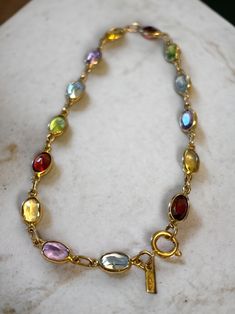 LOVELY Vintage 14K Yellow Gold Multi-Color Gemstone 7" Bracelet! * In beautiful pre-owned condition. * Beautiful gemstone bracelet with fourteen (14) assorted oval gems including garnet, amethyst, citrine, and peridot! * Hallmarked/Tested 14k * Weighs 2.8 Grams * Measures approximately 7" long from end to end. * Secure spring ring closure Please message me with any questions Shipped FAST and FREE, fully insured and in a gift box :) I guarantee item to be exactly as described and pictured. Dream Accessories, Gems Bracelet, Natural Gemstone Jewelry, Jewelry Lookbook, Jewelry Inspo, Gemstone Bracelet, Chain Link Bracelet, Spring Rings, Link Bracelets