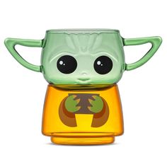 the baby yoda toy is sitting on top of a yellow cup with its eyes wide open