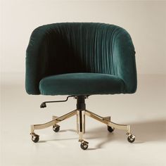 an office chair with wheels and a green velvet upholstered cushion on the back