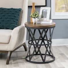 a living room with a chair, table and pictures on the wall in it's corner