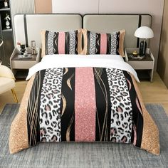 a bedroom with a leopard print comforter and pillows