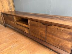 a wooden entertainment center with two drawers