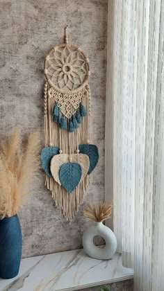 there is a wall hanging with two heart shaped decorations on the shelf next to it