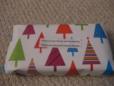 the wrapping paper has trees on it and is very colorfully printed with red, green, blue, and pink