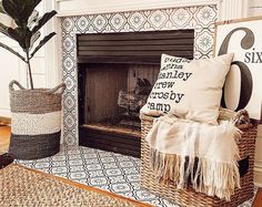 a living room with a fire place and rugs on the floor next to it