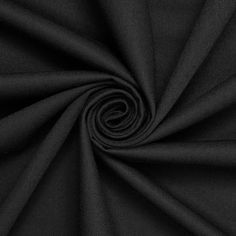 a black fabric with a spiral design on the center and bottom half, in an irregular pattern