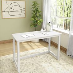 a white desk sitting in front of a window next to a potted green plant