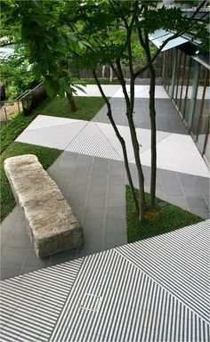 a stone bench sitting next to a tree