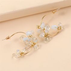 Frame your face with the sparkling elegance of this pair of flower drop earrings made with clear resin and an 18k gold plating. 1.46'' W x 1.46'' L 18k gold-plated copper / resin Flower Drop Earrings, Flower Plates, Clear Resin, Gold Plating, 18k Gold, Pearl Earrings, Gold Plate, Copper, Sparkle