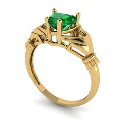 a gold ring with an emerald stone in the center