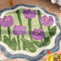 a rug with purple flowers is on the floor