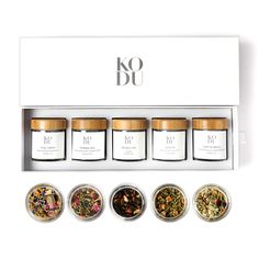 six different spices are in a white box with gold trimmings on the top