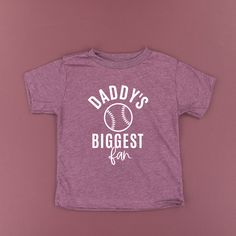 All Little Mama shirts are unisex sizing. Please reference size charts before purchasing. Graphic Print Baseball Jersey For Fans, Baseball Tops With Team Name And Collar, Baseball Collar T-shirt With Team Name For Game Day, Sports Season Graphic Print Top With Baseball Collar, Graphic Print Tops With Baseball Collar For Sports Season, Baseball Season Fan Merchandise Graphic Tee, Baseball Season Fan Merchandise Graphic Tee Shirt, Sports Fan T-shirt With Baseball Collar, Sports Fan T-shirt With Team Name And Baseball Collar