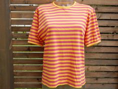 Please add your phone nr. for shipping:)Marimekko cotton ladies/ unisex T- shirt.  Color: yellow/ pink stripes Material: 100%  cotton Size: Medium Measured Flat: sleeve 23 cm (9") shoulders 46 cm (18.1") armpit to armpit 51 cm (20.1") total length 63 cm (24.8") Condition: in very good vintage condition. Please read my shop policies before purchase! Pink Cotton Top With Contrast Stripes, Summer Cotton T-shirt With Horizontal Stripes, Retro Striped T-shirt For Summer, Cotton T-shirt With Horizontal Stripes For Summer, Striped T Shirt, Short Sleeve T Shirt, Pink Shorts, Pink Stripes, Kids Tops