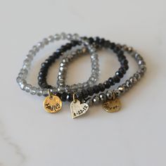 Add some bling to your wrist with our Personalized Crystal Stacks! You can personalize your stack bracelet with a name, date, initials, or a word of choice on a simple, classic disc charm. With neutral colors and faceted beads that shine and shimmer in the light, you can be reminded of a motivating word, memory, or special loved one whenever you look down at your wrist! A perfect gift for the everyday stack wearing lover! *Elastic stack bracelets are made with 6mm faceted crystals *Personalized Black Hand Stamped Jewelry For Everyday, Black Hand Stamped Everyday Jewelry, Stack Bracelets, Stack Bracelet, Chosen Family, Bead Store, Original Bags, Bracelet Crafts, Faceted Crystal