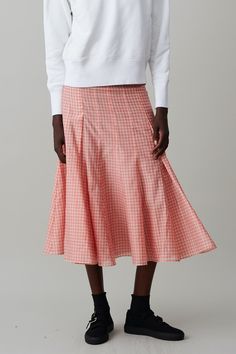 The Diya Skirt is a paneled and subtly pleated skirt that hits above the ankle. In lightweight gingham, Diya sits on the natural waist, is fitted through the waist and hips and is balanced with a flouncy skirt. Features a side zip for ease. Fitted Gingham Skirt For Summer, Skirted Bottoms With Pleated Hem For Spring, Spring Plaid Chic Skirt, Chic Pleated Plaid Skirt, Chic Plaid Flared Skirt, Chic Plaid Skirt For Spring, Spring Plaid Ruffled Skirt Bottoms, Gingham Tiered Skirt For Spring, Chic Gingham Tiered Skirt