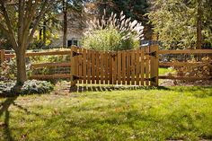 a wooden bench sitting in the middle of a lush green park