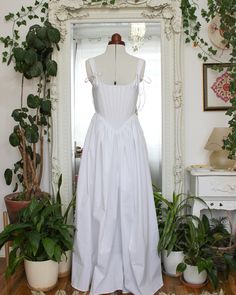 This lightweight cotton corset dress is perfect for summertime picnics, frolicking through flower fields, brunch dates, and even as a wedding dress for the cottagecore princess bride. The corseted bodice is lined with cotton coutil and boned with stainless steel. This dress has large pockets, making it practical as well as beautiful.  This dress can also be made in white duchess satin, which is a heavy, high quality, luxurious fabric perfect for a wedding dress.  The corseted bodice reduces your White Balletcore Corset Dress For Spring, Summer Dresses With Fitted Bodice For Gatherings, Elegant Cotton Corset Dress For Summer, Spring Balletcore Dress With Corset Back, Cotton Dress With Fitted Bodice For Garden Party, Cotton Dress With Sweetheart Neckline For Garden Party, Balletcore Dresses With Sweetheart Neckline For Summer, Summer Sweetheart Neckline Balletcore Dress, Summer Corset Dress With Balletcore Style