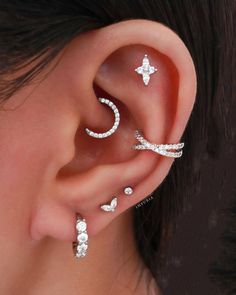 a woman with three ear piercings on her left side and one behind the ear