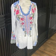 Great Johnny Was White Embroidered Tunic. V Neck Has Three Functional Buttons And A Tie Making It Very Versatile. About 19 Across And 28 Length From Shoulder. Great Summer Top That Would Be Phenomenal With Jean Shorts And A Wedge Sandal. Multicolor Embroidered Long Sleeve Top For Vacation, Long Sleeve Embroidered Top For Vacation, Long Sleeve Floral Embroidered Top For Beach, Multicolor Embroidered Long Sleeve Beach Top, White Long Sleeve Embroidered Top With Floral Print, White Long Sleeve Top With Floral Embroidery, Long Sleeve Embroidered Top For Beach, White Chikankari Embroidered Top For Beach, White Embroidered Floral Top For Vacation