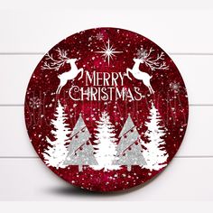 a red and white christmas ornament with trees