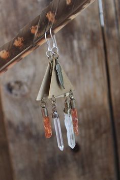 These boho style earrings are made with raw orange kyanite and clear quartz, brass triangles, brass feather and sterling silver ear wires. These earrings are medium weight, comfortable, delicate and feminine pieces, the perfect accessories to complement any bohemian and tribal style! Kyanite, known as the stone of "creativity", instills a sense of childlike joy in all of us, allowing us to put our imaginations to work and then go out and share our creations with others, without fear of being jud Orange Kyanite, How To Clean Crystals, Kyanite Crystal, Boho Style Earrings, Power Crystals, Quartz Earrings, Clear Quartz Crystal, Boho Stil, Wire Earrings