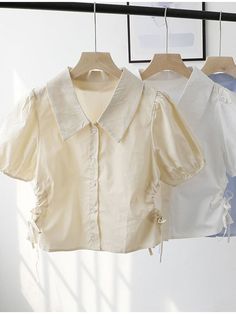 This shirt is perfect for those who are looking for a new shirt for a good price. It is fashionable, stylish, and it will look great on anyone who wears it. Do you wanahavit? Casual Collar Padded Blouse, Summer Collared Top With Buttons, White Kawaii Cotton Top, Cheap White Button-up Cropped Shirt, White Button-up Tops With Patch Pockets, White 3/4 Sleeve Top With Button Closure, White Cotton T-shirt With Button Closure, White Summer, White Crop Top