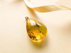 "SUBSCRIBE and get 10% OFF! http://eepurl.com/glhv05 After you have subscribed, please contact us at amber@torvela.com for the discount code. Natural Baltic amber green color pendant shaped in a thick drop form goes perfectly with every outfit! Perfect choice to brighten up office outfit or look even more beautiful on a special occassion! MATERIALS AND SIZE: Stone: 100% Natural Baltic Amber Other materials: silver 925 Weight: 8,5g (0.29 oz) Pendant size: 3,5cm (1,37 in) x 2,7 cm (1,06in) Total l Elegant Yellow Baltic Amber Necklaces, Yellow Teardrop Necklace For Formal Occasions, Yellow Teardrop Necklace For Formal Events, Elegant Handmade Drop Earrings As Gift, Formal Yellow Teardrop Pendant Jewelry, Elegant Handmade Drop Gift, Formal Yellow Teardrop Necklace, Unique Yellow Teardrop Jewelry, Handmade Yellow Drop Jewelry