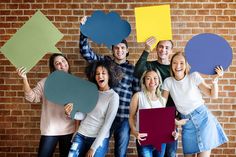 a group of people holding up speech bubbles