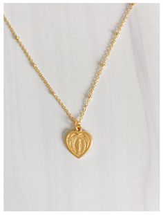 Share your love of the Blessed Virgin Mary with our Heart Shaped Miraculous Medal Necklace. Featuring an 18" chain with an image of the Blessed Virgin Mary. Makes a lovely gift for Confirmations or First Holy Communions. 18" chain 14k gold over brass designed and made by a small, woman owned jewelry brand and studio based in California Catholic Candles, Miraculous Medal Necklace, Catholic Necklace, The Blessed Virgin Mary, Catholic Jewelry, Blessed Virgin, Blessed Virgin Mary, Miraculous Medal, Catholic Gifts