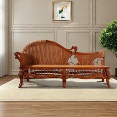 a wooden bench sitting on top of a hard wood floor next to a potted plant