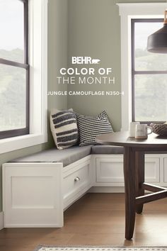 a corner bench in front of a window with the words behrt color of the month on it