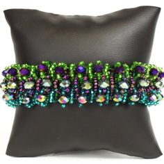 Czech Glass 3 Row Beaded Style Iris Mix Jewel Tone Fashion Statement Bracelet Purple, Green & Blue Iridescent And Czech Glass Beads One Of A Kind Handmade Bracelets/No Two Bracelets Are Exactly Alike Note: Colors & Beads Will Vary. Total Length Of 8.0" X 1.0" Wide Easy To Open/Close Magnetic Clasps. Handmade In Guatemala Using Artisan Crafted Czech Glass Beads. Czech Glass Beads Are Known For Their Quality, Sparkling Vibrant Colors And Wonderful Texture. Principles Of Fair Trade Upheld Purple Jewelry For Mardi Gras, Green Jewelry For Mardi Gras Party, Purple Beaded Jewelry For Mardi Gras, Bohemian Purple Crystal Bracelet For Party, Purple Round Bead Crystal Bracelet For Parties, Purple Round Beads Crystal Bracelet For Party, Purple Crystal Round Beads Bracelet For Party, Purple Round Beaded Crystal Bracelet For Parties, Handmade Adjustable Jewelry For Mardi Gras