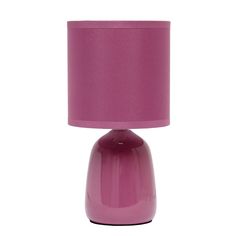 a pink table lamp with a purple shade on the base and a white light behind it