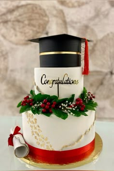 a graduation cake decorated with holly and red berries